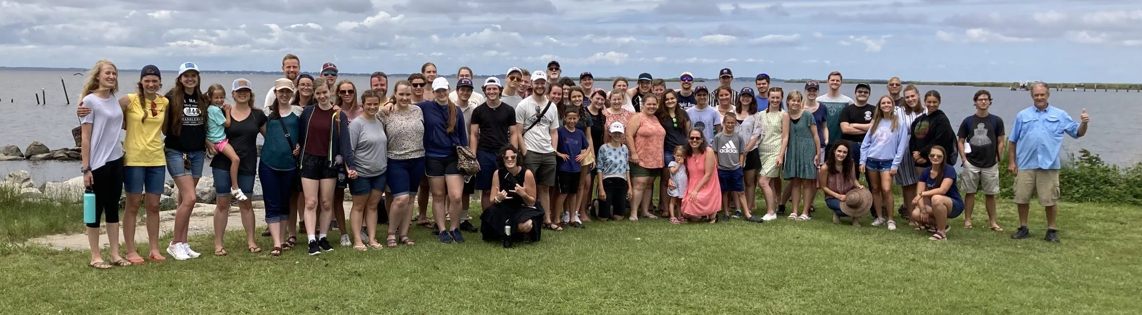 Poiema retreat attendees gathered beside the water